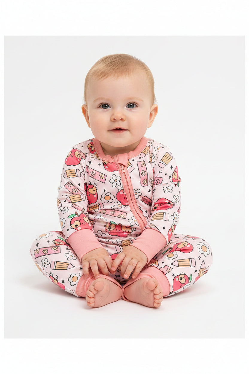 Soft baby girl sleeper romper with pink cuffs and fun print